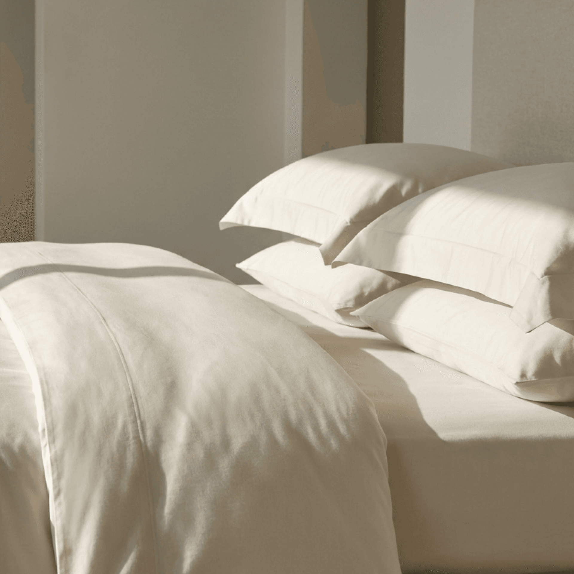 A made bed with white sheets